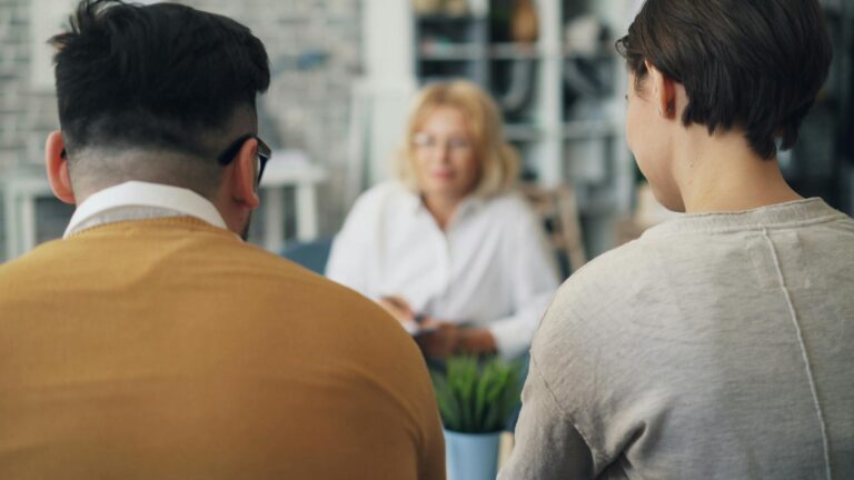 A woman and man sitting at a table talking