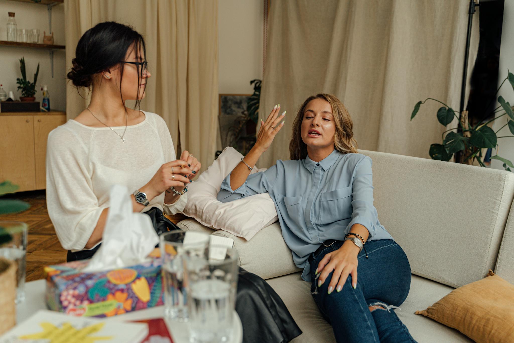 Woman in White Long Sleeve Shirt Sitting Beside Woman in White Long Sleeve Shirt